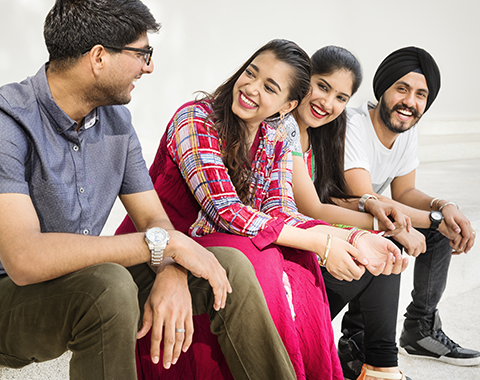 Hindu, Jain, and Sikh young singles laughing together at an HMEurope event